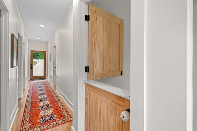 corridor featuring baseboards, recessed lighting, and light wood-style flooring