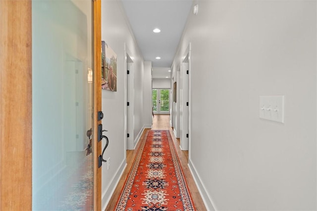 corridor with recessed lighting and baseboards