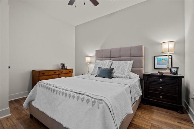 bedroom with baseboards, ceiling fan, and wood finished floors