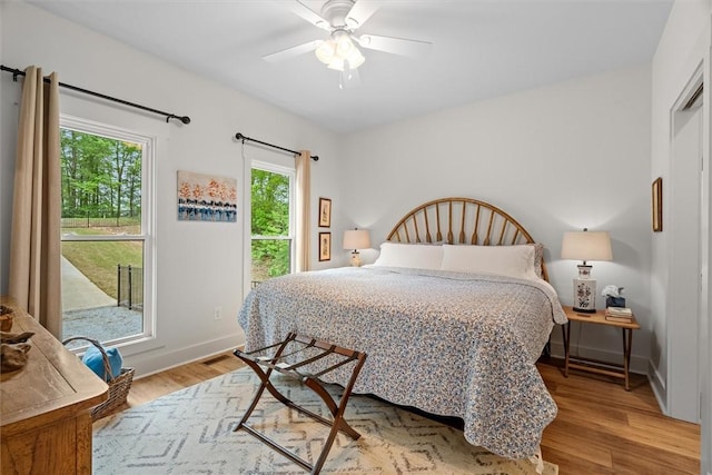 bedroom featuring baseboards, a ceiling fan, and wood finished floors