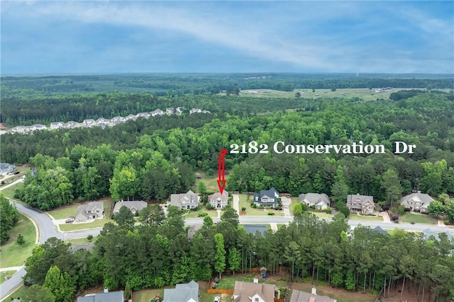 2182 Conservation Dr, Auburn, AL 36879 - aerial overview of property's location with a forest and nearby suburban area