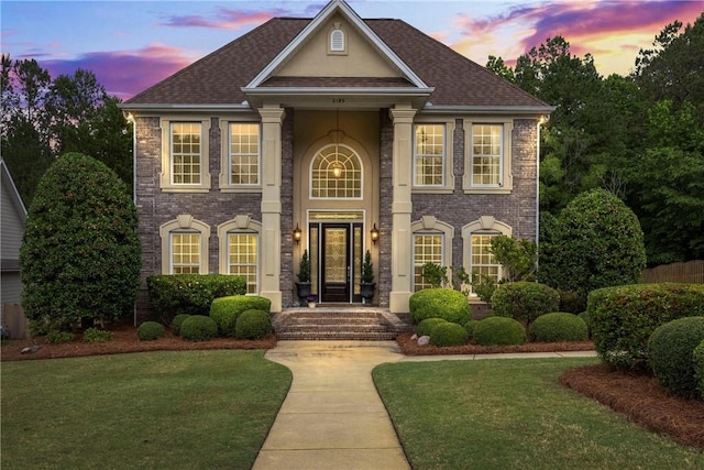 2182 Conservation Dr, Auburn, AL 36879 - view of front facade with a front lawn, brick siding, and roof with shingles