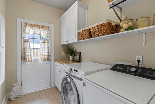 2182 Conservation Dr, Auburn, AL 36879 - laundry room with separate washer and dryer, cabinet space, and light tile patterned flooring