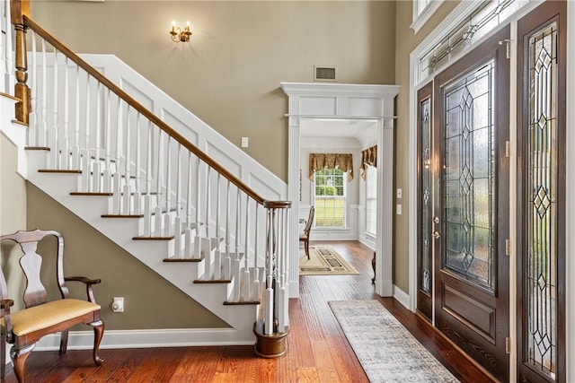 2182 Conservation Dr, Auburn, AL 36879 - entryway featuring stairs, hardwood / wood-style flooring, a towering ceiling, and baseboards
