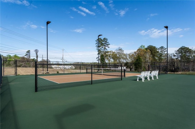 view of sport court with fence