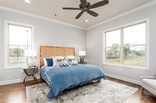bedroom with baseboards, multiple windows, visible vents, and ornamental molding