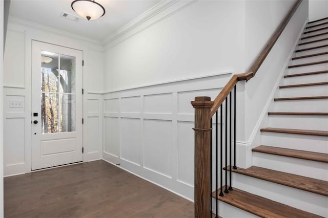 foyer entrance featuring dark wood-type flooring and ornamental molding