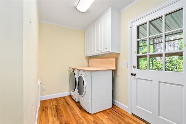 335 Woodfield Dr, Auburn, AL 36830 - laundry room featuring cabinet space, light wood-style flooring, washer and clothes dryer, and crown molding