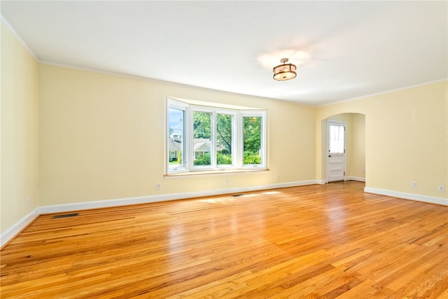 335 Woodfield Dr, Auburn, AL 36830 - spare room with ornamental molding, arched walkways, and light wood-type flooring