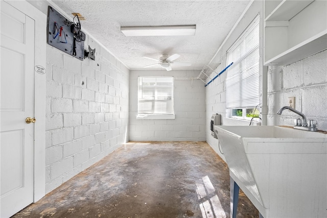 335 Woodfield Dr, Auburn, AL 36830 - washroom featuring concrete block wall, a textured ceiling, and ceiling fan