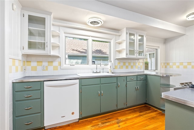 335 Woodfield Dr, Auburn, AL 36830 - kitchen with white dishwasher, open shelves, decorative backsplash, light wood-style flooring, and glass insert cabinets