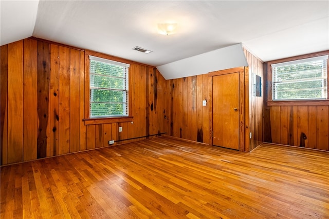335 Woodfield Dr, Auburn, AL 36830 - unfurnished bedroom featuring wood-type flooring, lofted ceiling, wood walls, and a closet