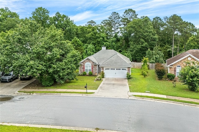 4339 Live Oak Dr, Auburn, AL 36830 - view of front facade featuring driveway, an attached garage, and a chimney