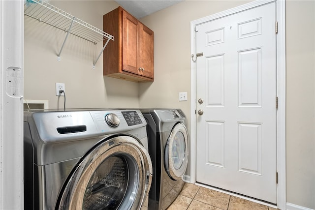4339 Live Oak Dr, Auburn, AL 36830 - washroom featuring washer and dryer, cabinet space, light tile patterned floors, and baseboards