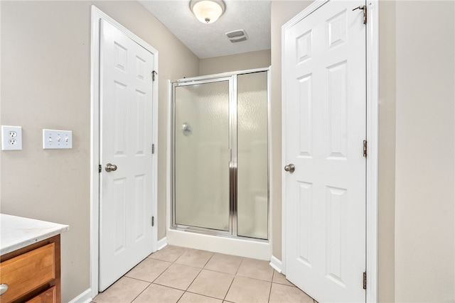 4339 Live Oak Dr, Auburn, AL 36830 - full bath with a shower stall, tile patterned floors, vanity, baseboards, and a textured ceiling