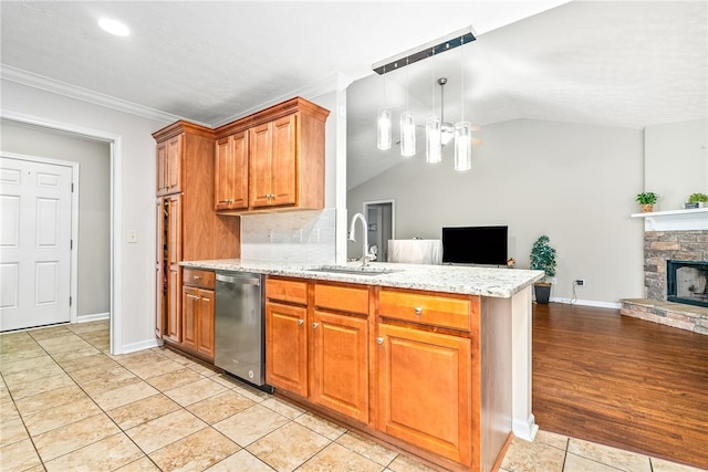 4339 Live Oak Dr, Auburn, AL 36830 - kitchen with dishwasher, a sink, open floor plan, lofted ceiling, and brown cabinets