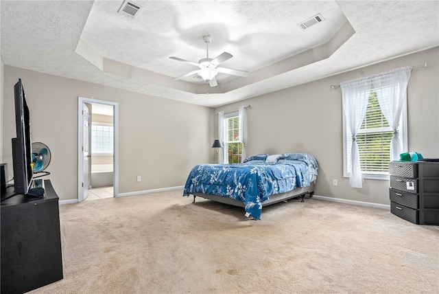 4339 Live Oak Dr, Auburn, AL 36830 - bedroom featuring a textured ceiling, a raised ceiling, carpet flooring, multiple windows, and baseboards
