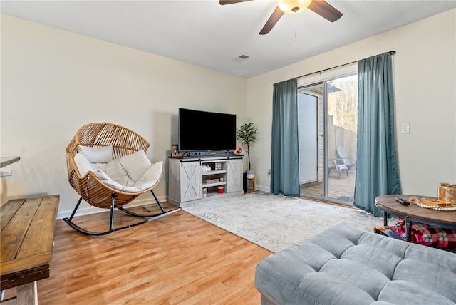 living room with ceiling fan and wood-type flooring