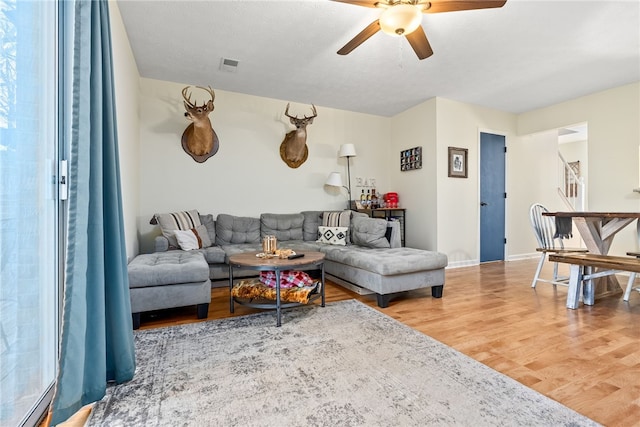 living room with hardwood / wood-style flooring and ceiling fan