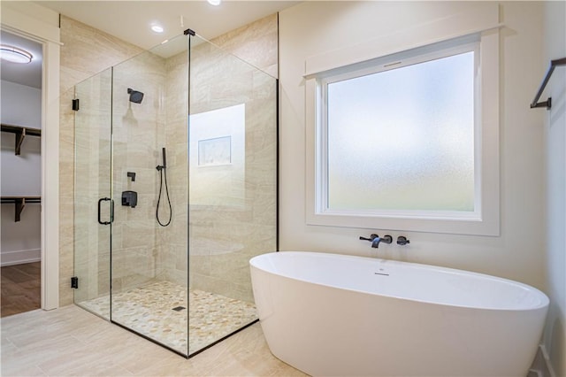 2307 Alpha Dr, Phenix City, AL 36867 - full bathroom featuring a stall shower, recessed lighting, a freestanding tub, and a spacious closet