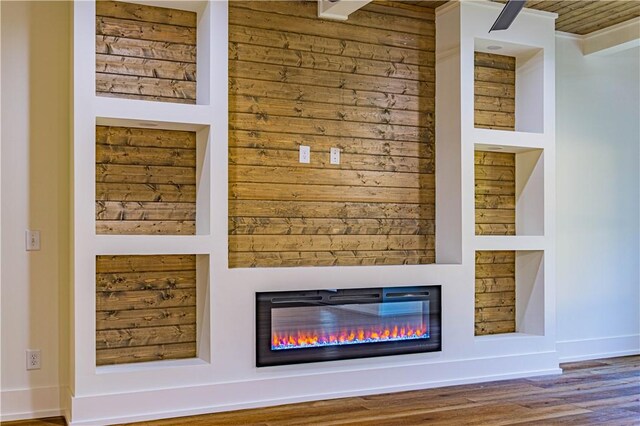 2307 Alpha Dr, Phenix City, AL 36867 - interior details featuring a glass covered fireplace, wood finished floors, and baseboards