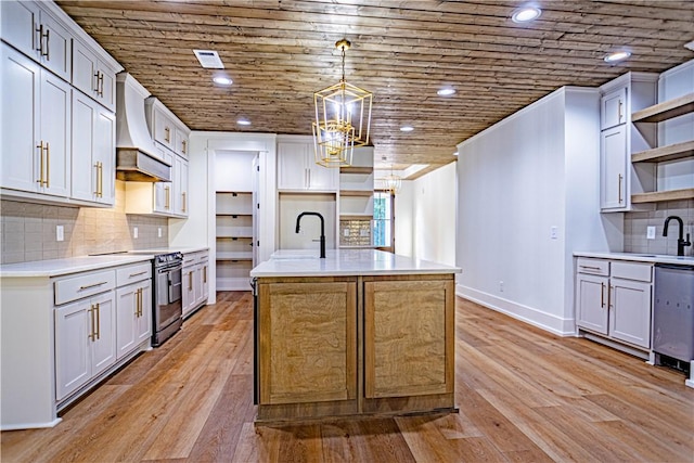 2307 Alpha Dr, Phenix City, AL 36867 - kitchen with a sink, stainless steel appliances, open shelves, premium range hood, and an island with sink