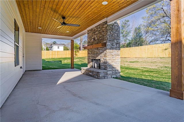 2307 Alpha Dr, Phenix City, AL 36867 - view of patio / terrace with ceiling fan, a fenced backyard, and an outdoor stone fireplace
