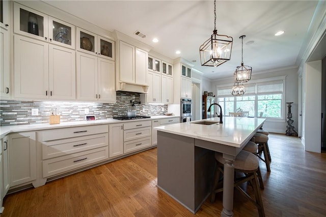 1659 N Donahue Dr, Auburn, AL 36830 - kitchen featuring a chandelier, gas stovetop, crown molding, a sink, and tasteful backsplash
