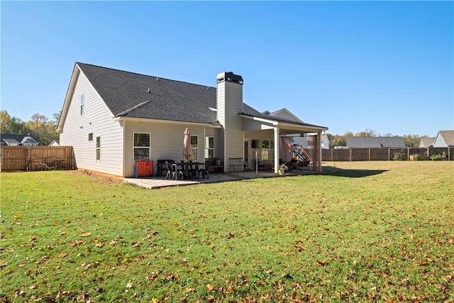 back of house featuring a yard and a patio