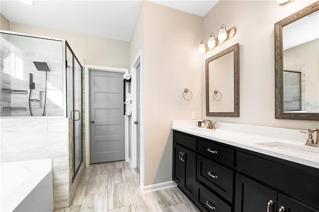 bathroom featuring separate shower and tub and vanity