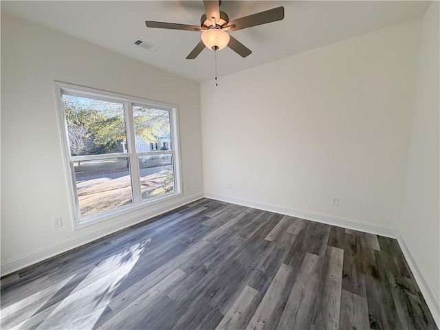 spare room featuring ceiling fan and dark hardwood / wood-style flooring