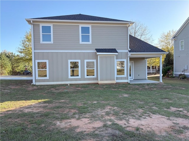 rear view of house featuring a lawn and a patio