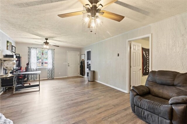 1066 Brown St, Valley, AL 36854 - living area with a ceiling fan, a textured ceiling, wood finished floors, and wood walls