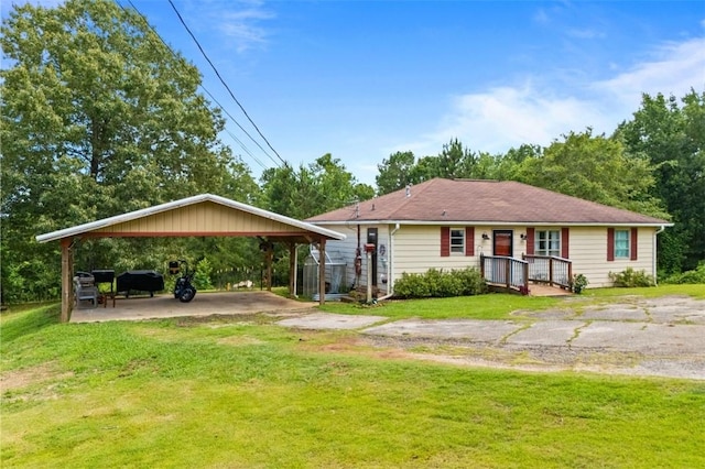 1066 Brown St, Valley, AL 36854 - view of front of home with a front yard, a carport, and driveway