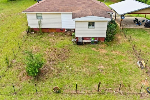 1066 Brown St, Valley, AL 36854 - rear view of property featuring a detached carport and roof with shingles