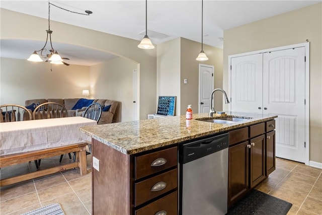 331 Lightness Dr, Auburn, AL 36830 - kitchen with stainless steel dishwasher, a sink, light tile patterned flooring, arched walkways, and dark brown cabinets