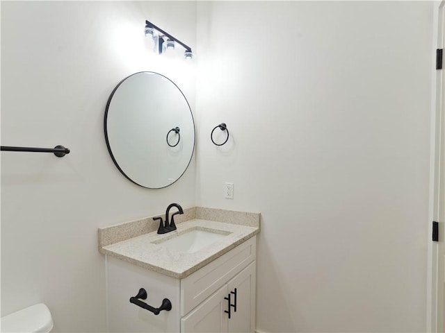 bathroom with toilet and vanity