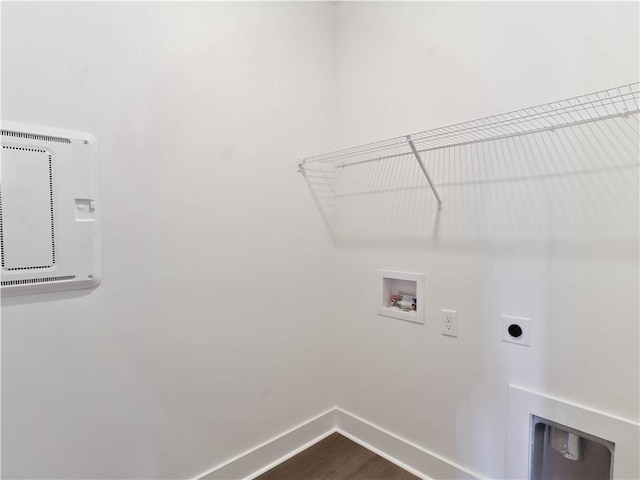 laundry area featuring baseboards, dark wood finished floors, laundry area, hookup for a washing machine, and hookup for an electric dryer