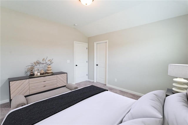 carpeted bedroom featuring vaulted ceiling