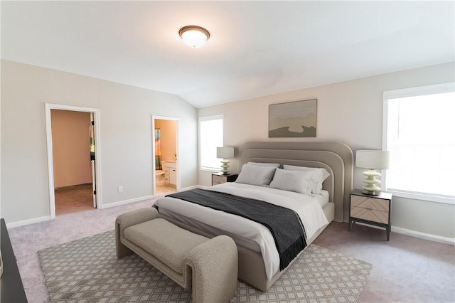 bedroom featuring ensuite bathroom, carpet floors, and multiple windows