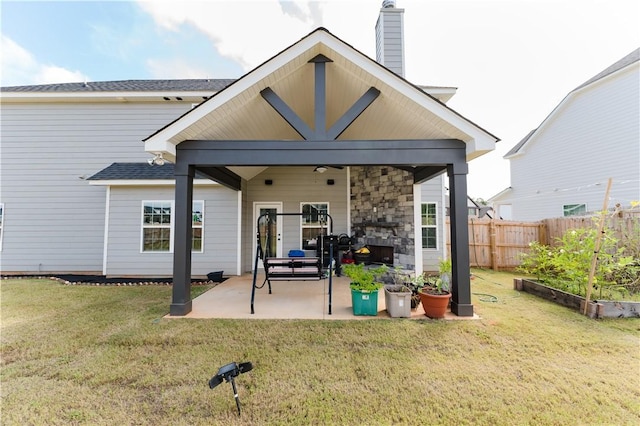 back of house with a yard and a patio