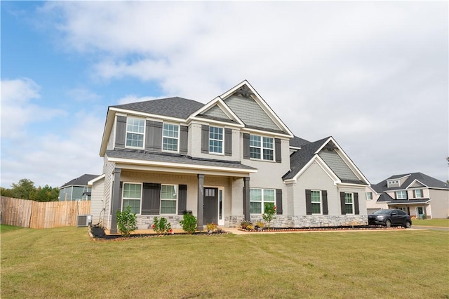 craftsman-style house with a front yard and central AC unit