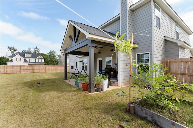 rear view of house with a patio and a lawn