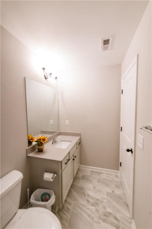 bathroom with vanity and toilet