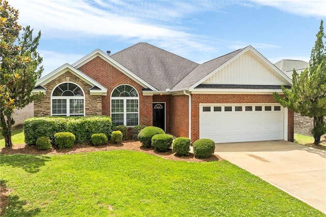 1317 Tulip Ct, Auburn, AL 36830 - view of front of property with a garage, a front lawn, board and batten siding, driveway, and brick siding