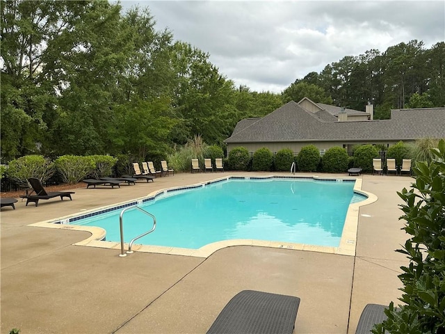 1317 Tulip Ct, Auburn, AL 36830 - community pool featuring a patio and view of wooded area