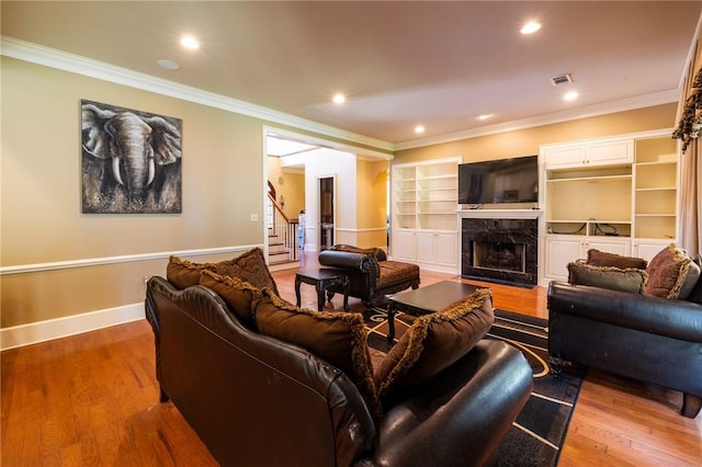 56 Peachwood Dr, Tallassee, AL 36078 - living area featuring wood finished floors, crown molding, baseboards, stairs, and a premium fireplace