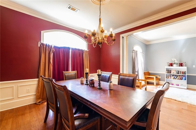 56 Peachwood Dr, Tallassee, AL 36078 - dining room with a chandelier, crown molding, wood finished floors, decorative columns, and wainscoting