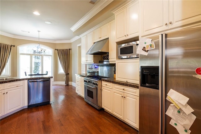 56 Peachwood Dr, Tallassee, AL 36078 - kitchen featuring stainless steel appliances, under cabinet range hood, a chandelier, ornamental molding, and dark wood-type flooring