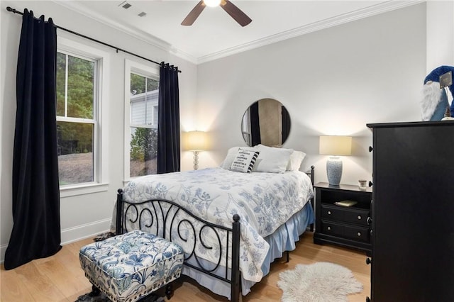 bedroom featuring ceiling fan, light wood-type flooring, and ornamental molding